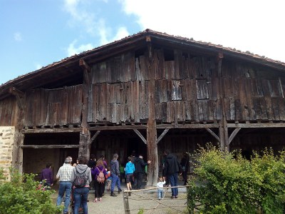 Exterior del caserío, soportal, visitantes en la visita guiada